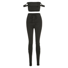 Black two-piece outfit with a top and pants on a white background