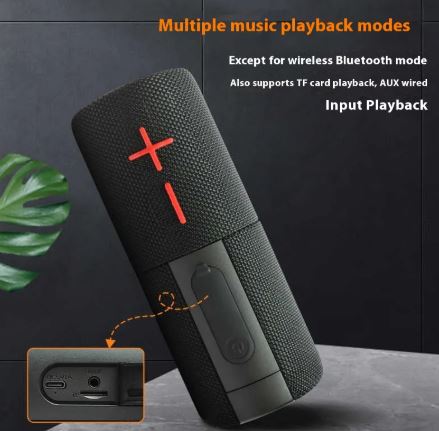 Black portable speaker with red logo on a dark background, featuring text about music playback modes.