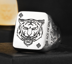 Silver dice with a tiger design and 'Ace of Spades' text on a dark background