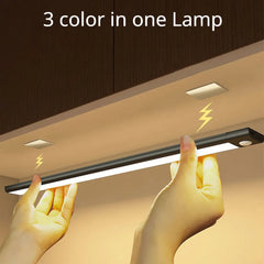 Light strip with hands holding it, labeled '3 color in one Lamp' above a cabinet.