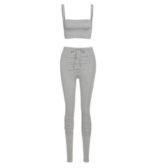 Gray crop top and leggings set on a white background