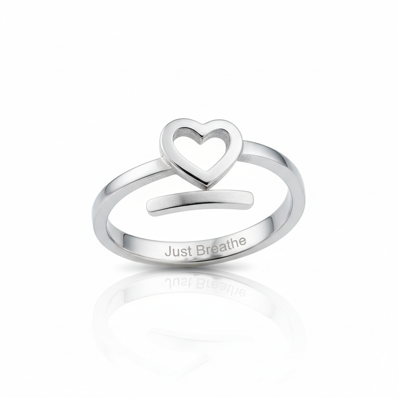 Silver spiral heart ring with Just Breathe engraving on white background